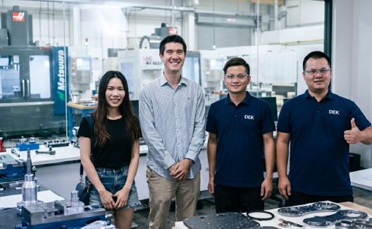 DEK engineers and visitors in the machine shop