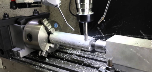 4-axis CNC milling in action, cutting a metal cylinder with precision