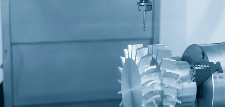 CNC milling machine cutting a detailed metallic part