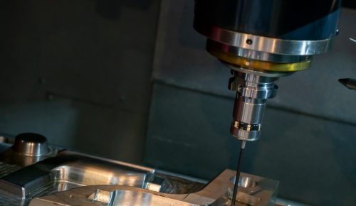 3 axis CNC machining center milling an aluminum bracket pocket