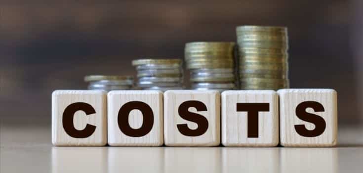 wooden blocks spell costs with coin stacks behind
