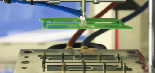 Green plastic parts held by CNC machine tool