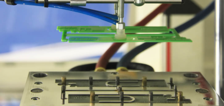 Green plastic parts held by CNC machine tool