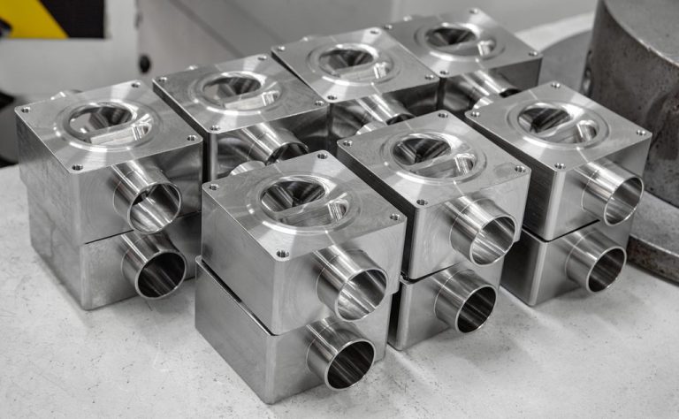 Stacked machined aluminum housings with ports and bolt holes