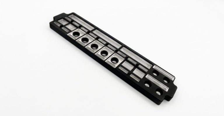 Black anodized aluminum aerospace component with precision holes