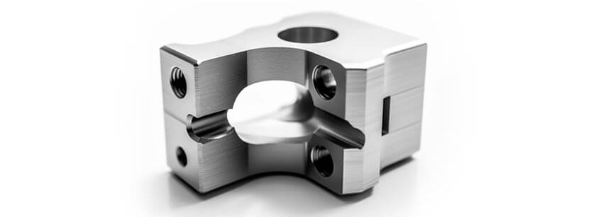 Machined metal bracket with holes and curved cutout