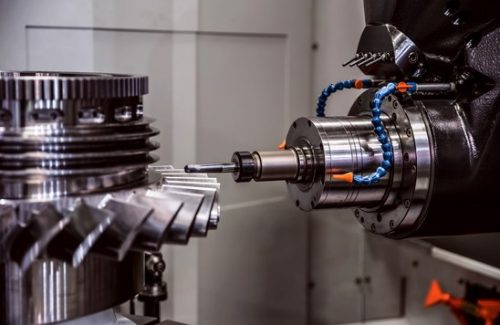 5-axis CNC machine cutting gear teeth on a large steel part