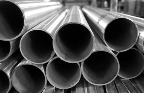 Stacked stainless steel tubes in workshop