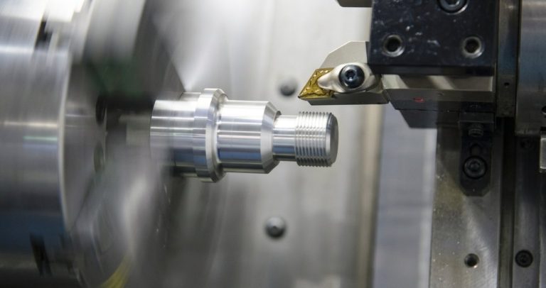 Alloy steel machining shaft on CNC lathe with insert