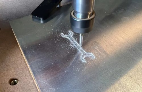 Cnc milling tool engraving wrench shape on aluminum plate
