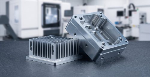 Aluminum 6063 CNC machined enclosure and heat sink on dark table