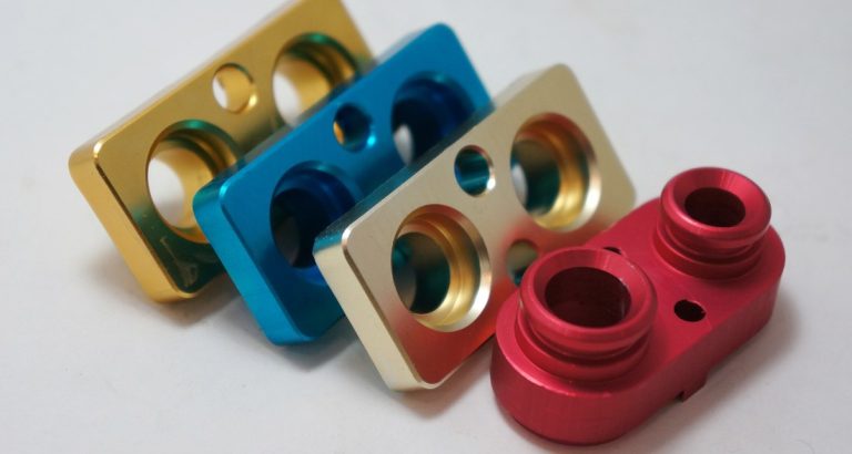 Anodized aluminum CNC machined brackets showing color finish results