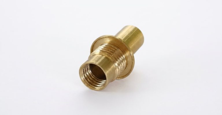 Brass threaded fitting with machined finish