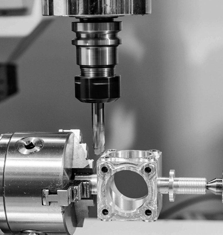 Mill-turn machining of a square aluminum part held in a lathe chuck