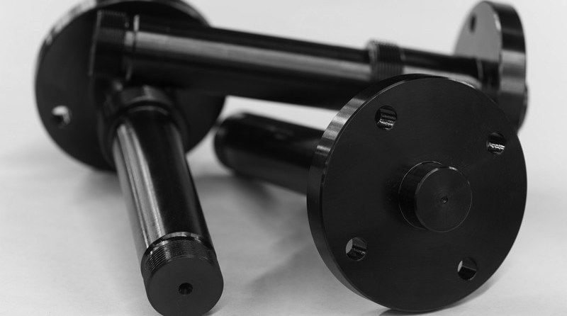 Steel flange showing bare metal and black oxide finish transition