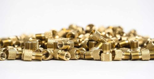 Brass fittings pile on white background