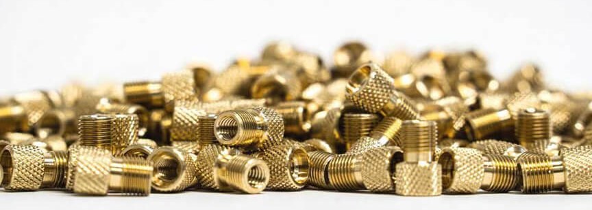 Brass fittings pile on white background