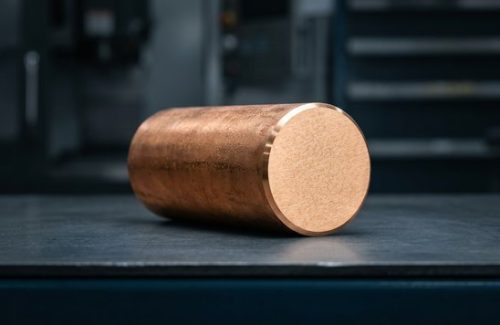 Raw bronze 932 round bar stock before CNC machining