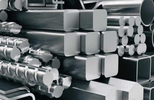 Stacked mild steel bars and tubes in warehouse