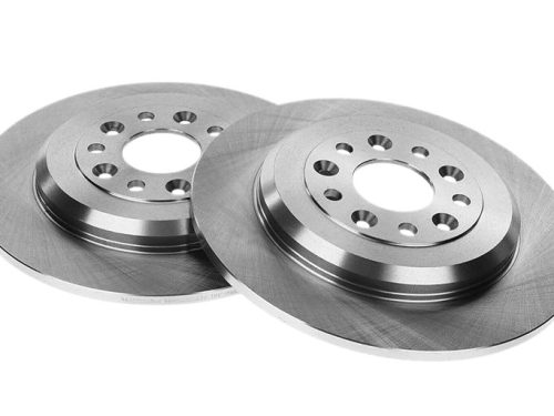Two machined flange parts on white background