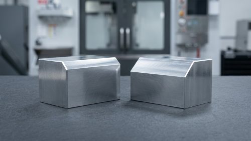 Machined aluminum parts comparing chamfer versus bevel edge geometry