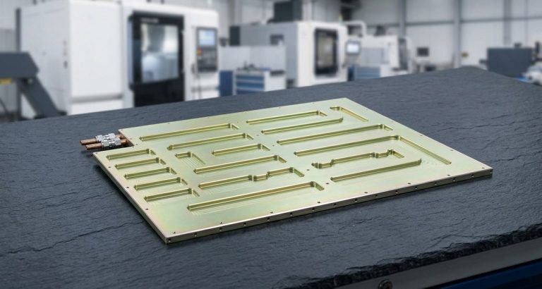 Chem film coated aluminum cold plate on dark worktable