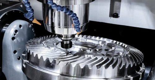 CNC milling machine cutting a precision metal gear prototype