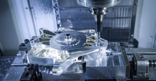 CNC milling machine cutting a complex aluminum prototype part