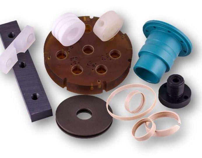 Assorted machined plastic parts on white background