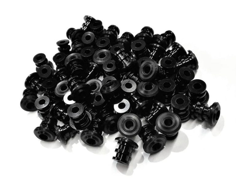 Black delrin plastic cnc machined parts pile