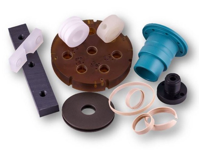 Assorted machined plastic parts on white background