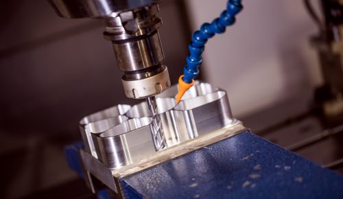 CNC milling machine cutting aluminum block with end mill