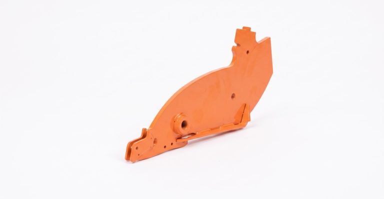 Orange plastic bracket with mounting holes and cutouts
