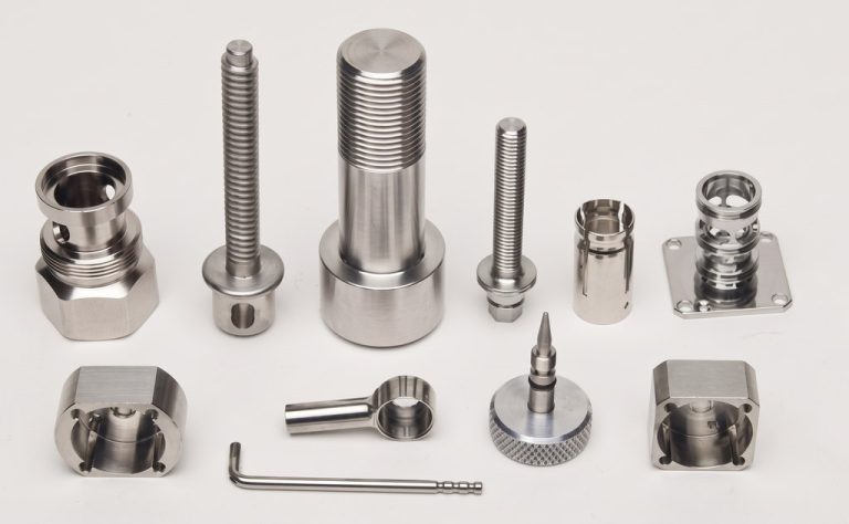 Precision machined metal parts with threaded and smooth finishes