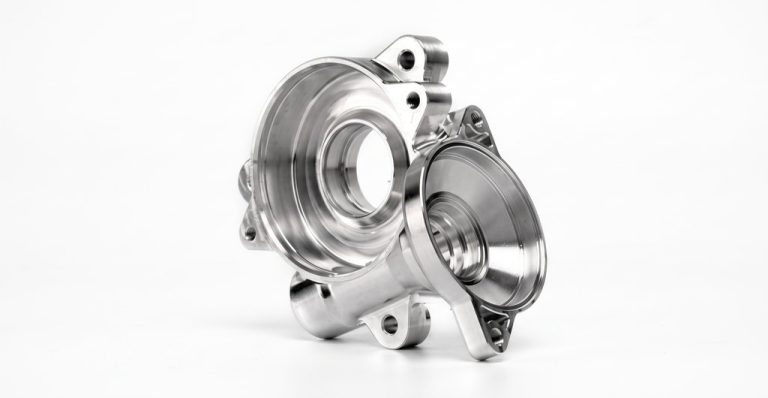 Machined metal housing with flanges and precision bores