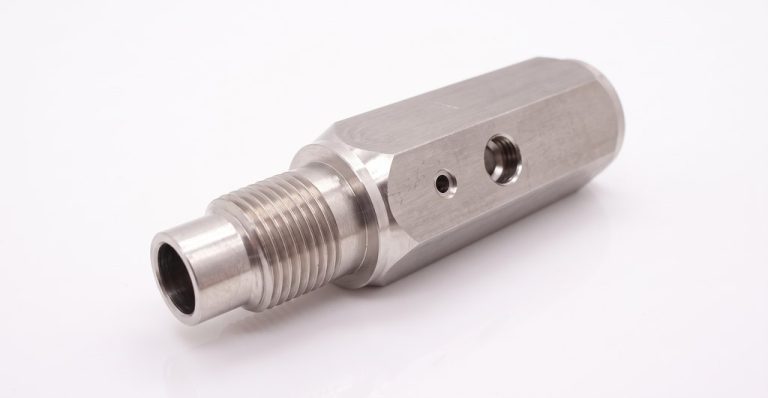 CNC machined metal fitting with threaded end and holes