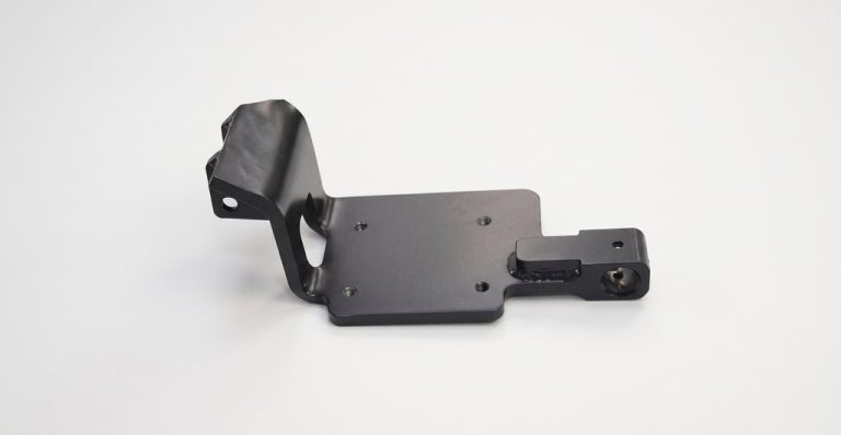 Black machined metal bracket with mounting holes