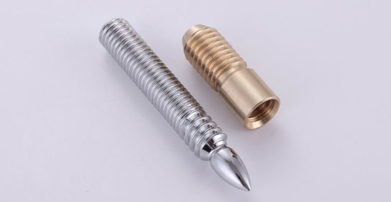 Two precision threaded metal parts, steel and brass finish
