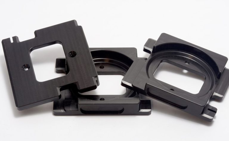 Black machined plastic enclosures with precise cutouts and mounting holes