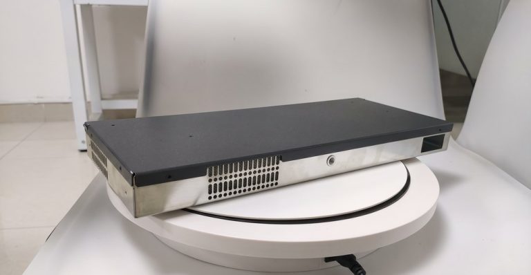 Black metal enclosure on rotating white platform