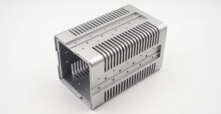 Machined aluminum housing with cooling fins and mounting holes