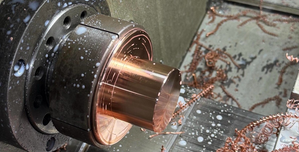 CNC turning of a copper part with chips