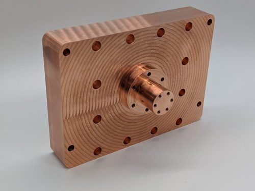 Large copper machined aerospace part with holes and concentric rings