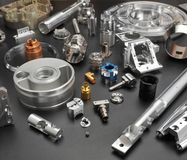 Custom machined stainless housing part on dark worktable