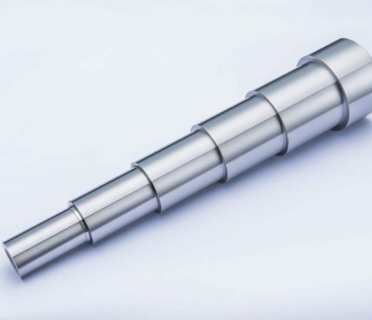 Ground steel bushings showing mirror finish from cylindrical grinding