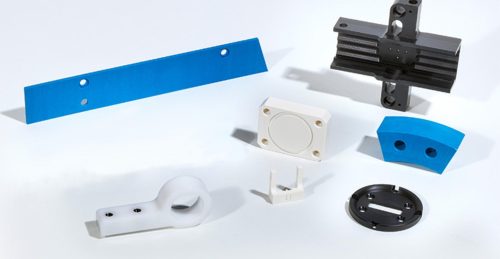 Acetal plastic machined parts on white background