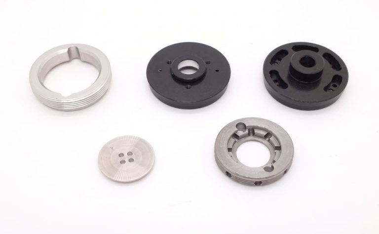 Five machined metal and plastic drone components
