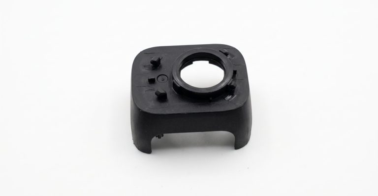 Black plastic drone part with circular opening and mounting points