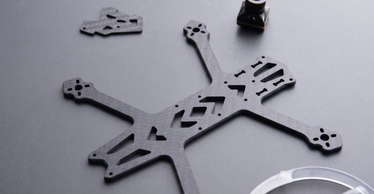 Black CNC-machined drone frame with precision cutouts and mounting holes