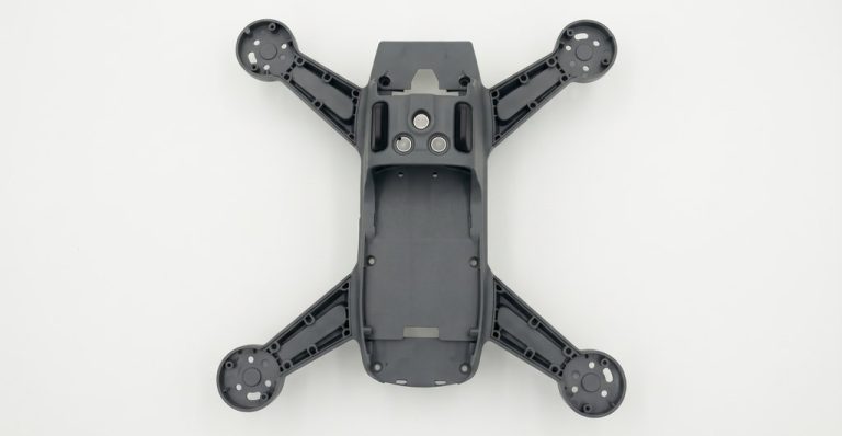 Black drone frame with four arms and mounting holes